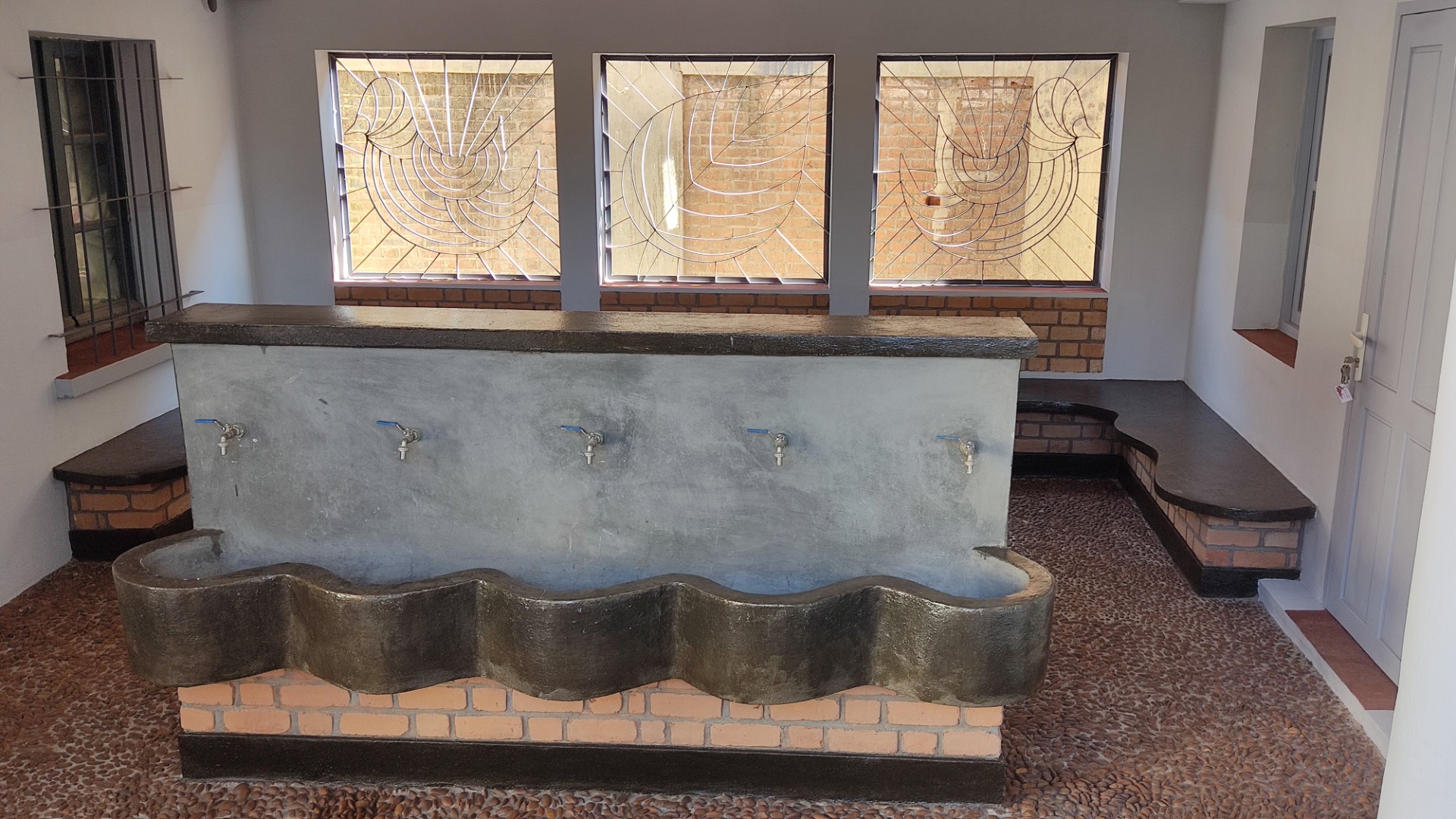 Shaded area inside the staircase with a drinking water station.
